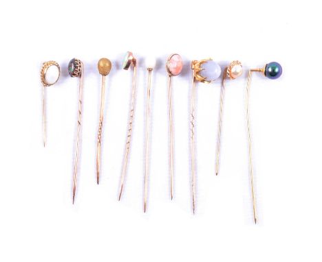 Nine small stick/tie pins, an 8.2mm pale blue deep cabochon cut six ray star stone; a pear shaped opal; oval cabochon cut opa