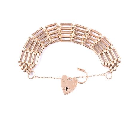A 9 carat yellow gold 19.2mm wide five bar gatelink bracelet, padlock fastener and safety chain, 17cm, 20.2g.