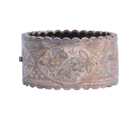 A Victorian style white metal half hinged bangle, floral and geometric pattern to front, plain polished back, both having a s