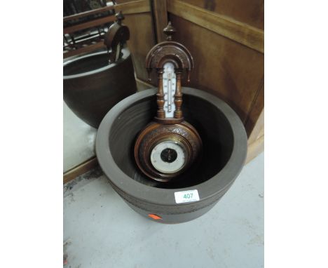 A modern planter and a traditional aneroid barometer