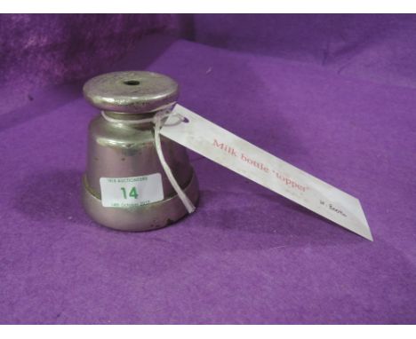 A vintage dairy farm tool for topping milk bottles by H King and Son