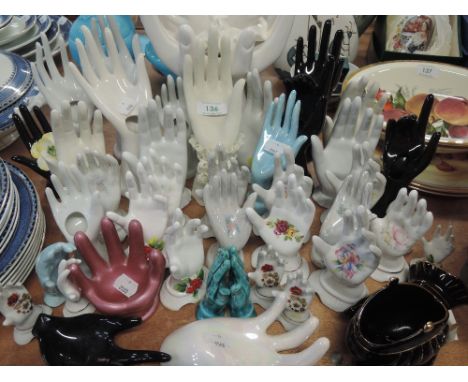 A selection of ceramic hands and jewellery stands