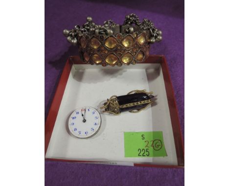 An Indian white metal bangle having amber glass and chain decoration, a vintage watch face and a beetle brooch having purple 