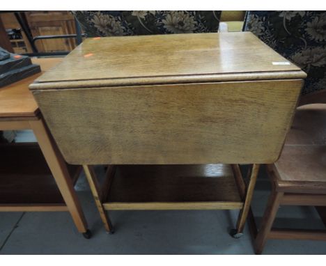 A vintage golden oak tea trolley