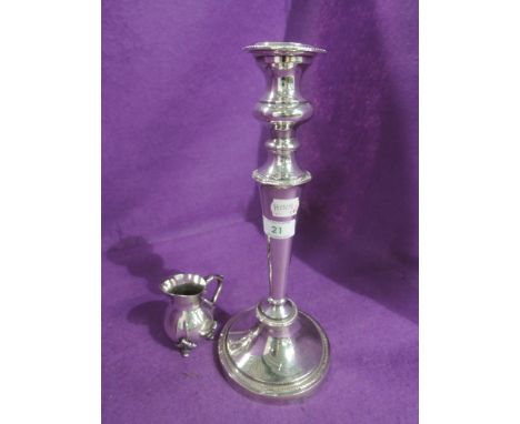 A Sheffield plate candle stick of traditional form and a small plated cream jug