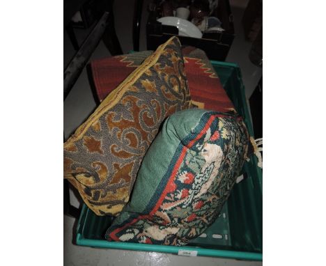 A vintage wall covering and two cushions