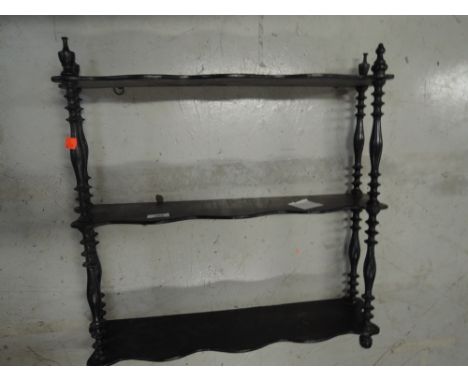 A Victorian ebonised wall shelf