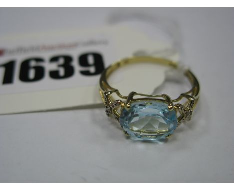 A Modern Single Stone Dress Ring, oval four claw set to the centre, between inset openwork shoulders, stamped "9K".