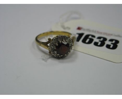 An 18ct Gold Cluster Dress Ring, with claw set centre highlight within inset border, between textured tapered shoulders.