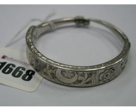 A XX Century Islamic Bangle, of tapering design, detailed in relief.