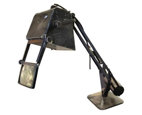 An early 20th century black painted metal angle poise lamp with lens