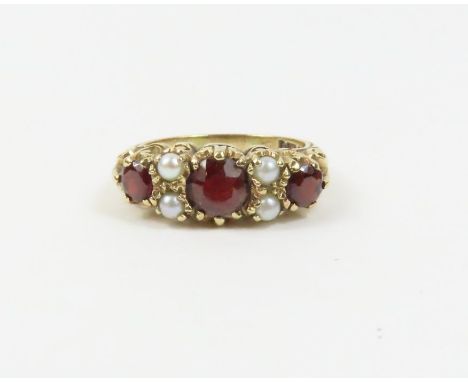 A 9ct gold garnet and split pearl ring, in the Victorian style, finger size M 1/2, 3.4g gross (the pearls untested and unwarr