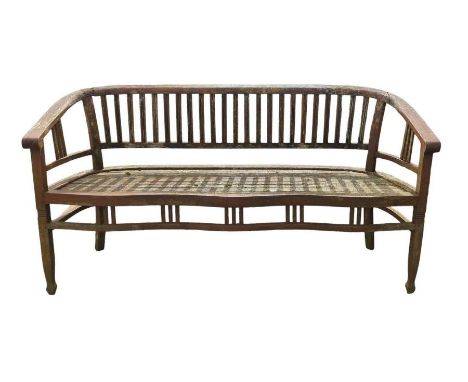 A weathered teak garden bench with curved seat rest by the solid wood company, 166cm wide, 87cm high, 61cm deep