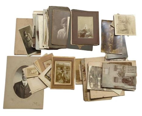 A quantity of late 19th and early 20th century family photographic portrait cards and postcards, includes children, man sitti