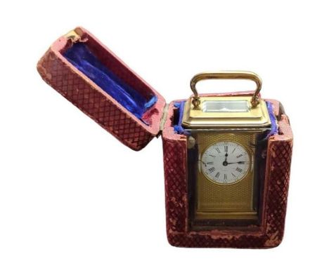 A small 19th century carriage timepiece in brass case, having circular white enamel dial with blued steel hands and within gu