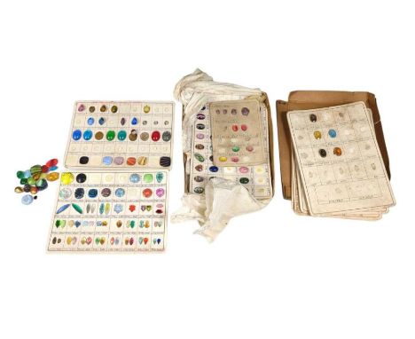 A collection of vintage jewellery trade rep cards, with various paste and plastic stones and beads attached