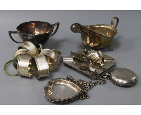 A set of six silver engine-turned napkin rings, a silver pocket watch, sauce boat, sugar bowl and sundries, including a pair 