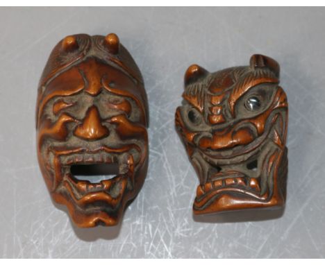 A Japanese Meiji carved wood Noh mask netsuke of Hannya and another similar