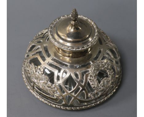A circular cut glass silver-mounted inkwell, the heavy inkwell with star-cut base, the pierced mount having hinged cover with