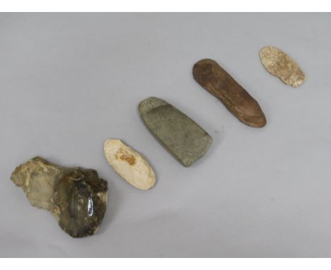 A prehistoric polished grey flint axe head, L 11cm and four other items, including a large Acheulean hand axe, Great Blakenha