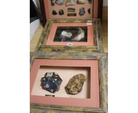 A framed display containing a Paleolithic Henley Pit chopper core and Moortown Pit handaxe and two other displays, including 