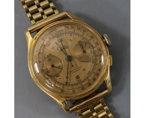 A gentleman's 18ct gold chronograph manual wind wrist watch on a 9ct gold bracelet.