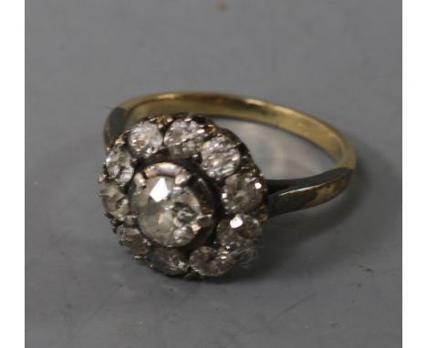 An early 20th century 18ct gold and diamond cluster ring, size K.