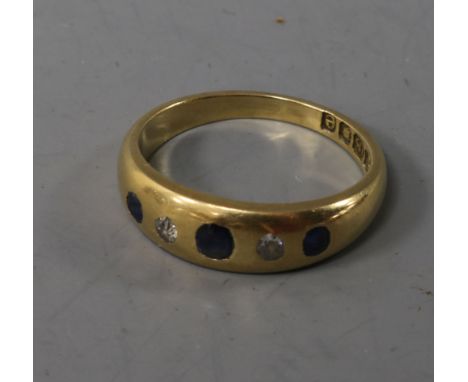 A late Victorian 18ct white gold, sapphire and diamond gypsy set ring, size M.