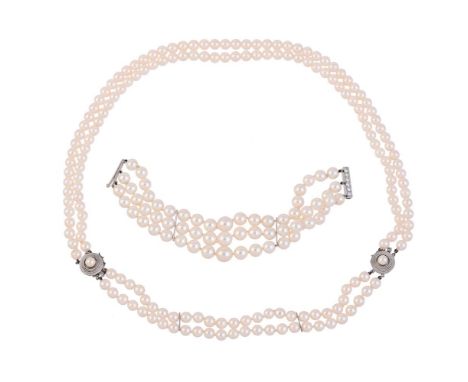 
	
		A THREE ROW CULTURED PEARL BRACELET WITH DIAMOND CLASP
		The graduated pearls on knotted strands, with bar spacers, to a