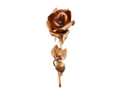 
	
		A RUBY AND GOLD COLOURED ROSE BROOCH
		The rose with textured petals and ruby accented stamen, the stalk with texture le
