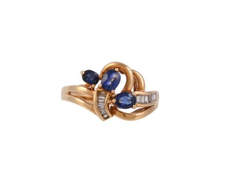 
	
		A SAPPHIRE AND DIAMOND RING
		The crossover ring with channel set baguette cut diamonds, and a trio of oval cabochon sap