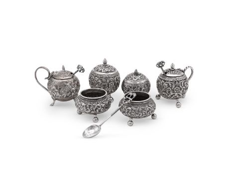 
	
		AN INDIAN SILVER FOUR PIECE GLOBULAR CRUET SET
		UNMARKED, EARLY 20TH CENTURY
		The mustard pot with a cone finial to th