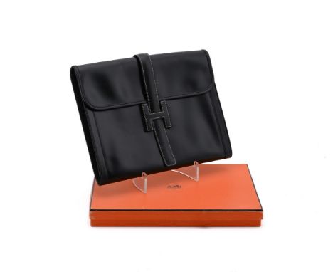 
	
		HERMES, JIGE MM 
		A LARGE BLACK LEATHER CLUTCH BAG, CIRCA 1970
		With a strap fastener, the flap opening to a canvas in
