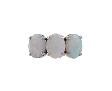 
	
		A THREE STONE OPAL RING
		The trio of oval cabochon opals within four claw settings, to pierced bar gallery, the shank s