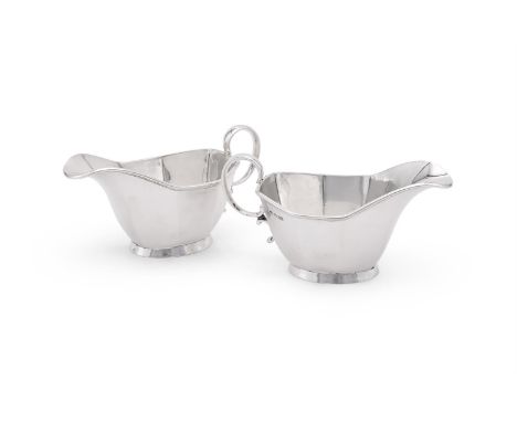
	
		A PAIR OF SILVER SAUCE BOATS 
		MARTIN HALL &amp; CO. LTD., SHEFFIELD 1931
		With a double scroll handle and on an oval 