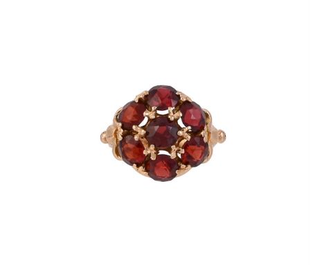 
	
		SOCCI MARIA, A 1970S GARNET CLUSTER RING
		The circular cut garnets with claw settings to lobed shoulders, the shank sta