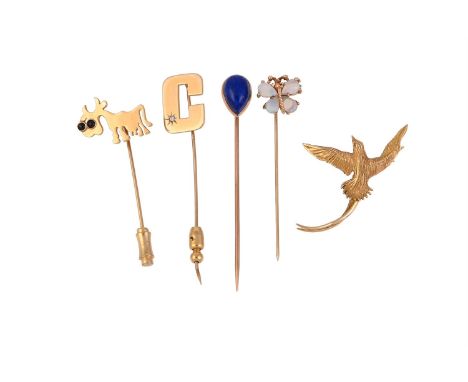 
	
		A COLLECTION OF FOUR STICK PINS AND A BIRD OF PARADISE BROOCH
		The first a stylised polished cow, with circular cabocho