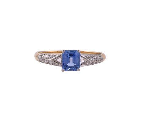 
	
		A SAPPHIRE AND DIAMOND RING 
		LONDON 1985 
		The step cut sapphire with canted corners in a four claw setting, between 