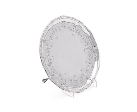 
	
		A GEORGE II SILVER SHAPED CIRCULAR WAITER
		JAMES STAMPED, LONDON 1779
		With a beaded border, engraved with a foliate b