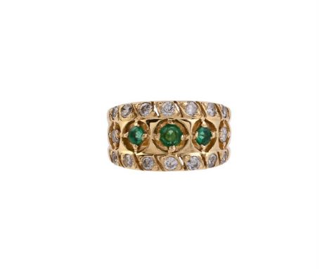 
	
		AN EMERALD AND DIAMOND RING
		The broad pierced gold coloured panel centred with a trio of circular cut emeralds with br