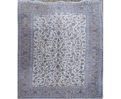 A very large 20th Century Persian Islamic wool floor carpet rug. Cream ground with blue repeating flowers and geometric borde