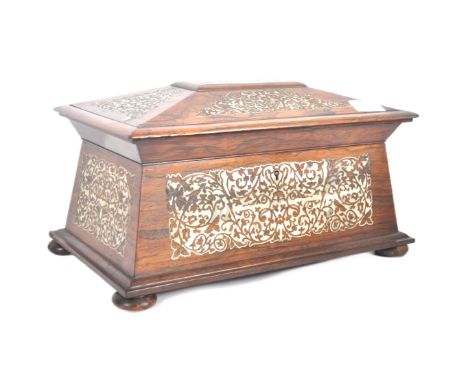 A 19th Century Victorian rosewood and mother of pearl inlay tea caddy of sarcophagus form. Intricate inlay throughout with th
