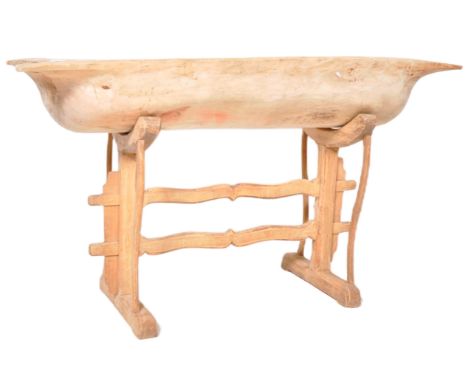 A 19th Century pine trough on stand of large form. Carrying handles to each end with all raised on a decorative carved stand.