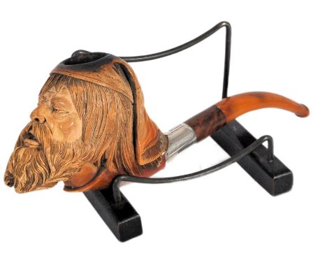 An early 20th century meerschaum tobacco pipe carved in the form of a bearded gentlemen wearing a night cap . The stem being 