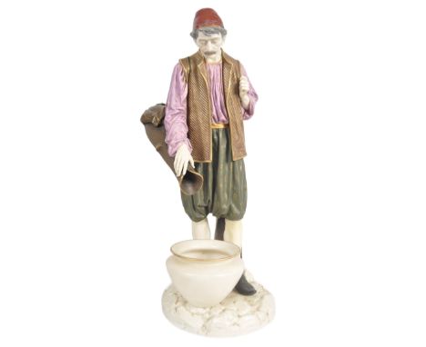 A 19th Century Hadley's Worcester large porcelain figurine depicting a male water carrier. The figure of the man modelled sta