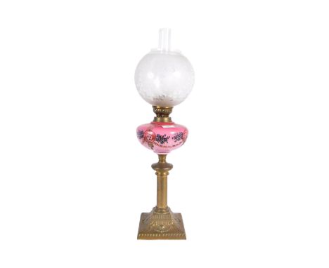A 19th Century Victorian oil lamp table light. Neoclassical cast brass base with knopped cylindrical column, pink glass reser