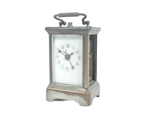 An early 20th Century miniature carriage clock (10cm). The brass cased clock having bevelled glass panels and swing handle at