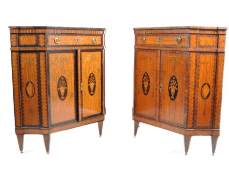 A pair of 19th Century French inlaid satinwood encoignure corner cabinets having fitted central drawer with gilded ring handl