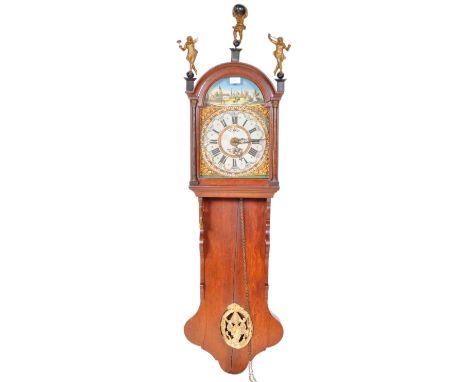 A 19th Century Dutch Friesland hanging wall staart clock / tail clock having a mahogany case with brass worked cherub finials