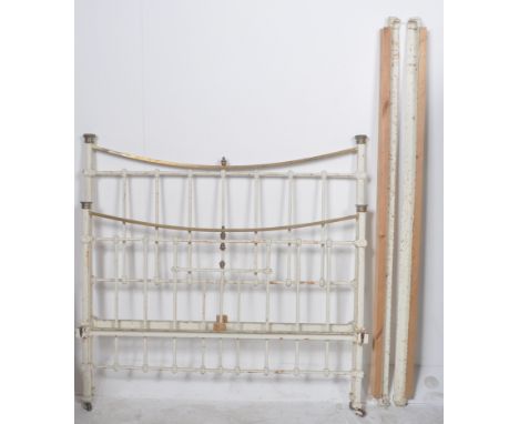 A 19th Century Victorian brass and iron double sized bed finished in white with straight and curved supports throughout. Meas